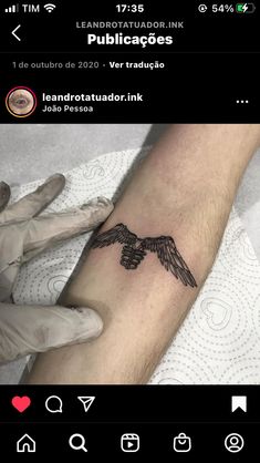 a person with a tattoo on their arm that has an eagle in the middle of it