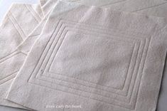 three pieces of white cloth sitting on top of each other