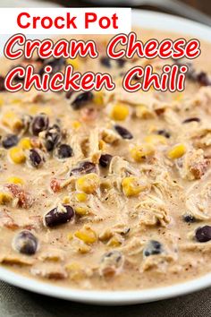 crock pot cream cheese chicken chili is shown in a white bowl with black olives and corn