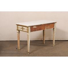 an antique desk with marble top and drawers