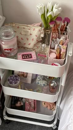 a white shelf filled with lots of makeup and other items