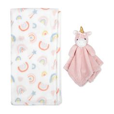 a pink unicorn blanket with a gold horn on it next to a baby's toy