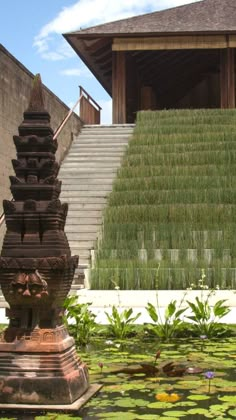 an elaborate fountain in front of a building with steps leading up to it and lily pads on the ground