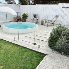 a small backyard with a pool and patio furniture