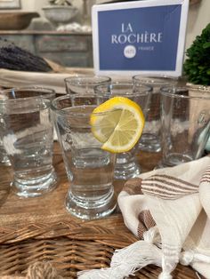 a table topped with glasses and a lemon slice