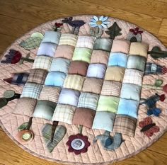 a round rug with many different pillows on it