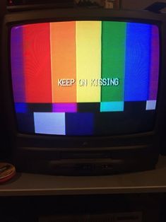 a television with the words keep on kissing written on it