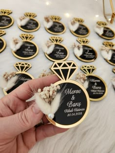 someone is holding up some wedding favors