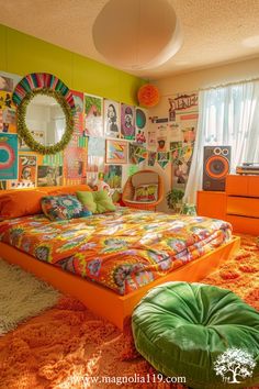 an orange bedroom with lots of pictures on the wall and bed in front of it