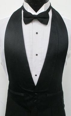 Black Satin Open Back(Backless) Vest & Bow Tie     This listing is for a fabulous Black Satin Open Back Vest and Matching Bow Tie.  The vest features a three button front and an open back.  It sports faux double besom pockets, shawl lapels, and satin buttons.  Quality and quite stylish vest.  Absolutely perfect for a wedding, prom, or a variety of other formal events.  From rental stock and&nb Black Vest Outfit Men, 1950 Mens Fashion, Black Suit Black Shirt, Black Vest Outfit, Vest Outfits Men, Mens Formalwear, Vest And Bow Tie, Man Suits