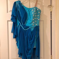 a blue dress hanging on a door