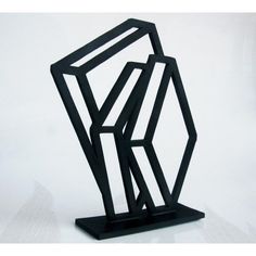 a black sculpture sitting on top of a white table