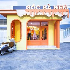 a scooter is parked in front of a store with mannequins