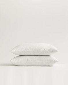 two white pillows stacked on top of each other