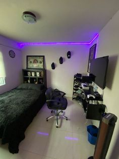 a bed room with a neatly made bed and purple lighting