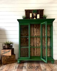 a green cabinet sitting on top of a wooden floor