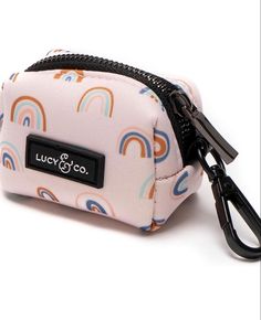 a small pink bag with rainbows on it and a black zippered closure that says lucky co