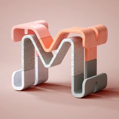 an abstractly designed object on a pink and grey background with the letter m in it's center