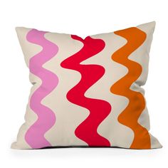 an orange, pink, and white pillow with wavy lines on the front is shown