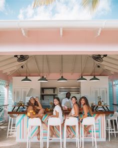 a group of women sitting at a bar