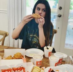 a woman sitting at a table eating food