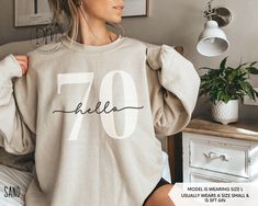 Step into your 70s in retro flair with our Hello 70 sweatshirt! This 70th birthday crewneck is a must-have for commemorating your Seventieth birthday in classic style. It also makes an ideal 70th birthday gift. ✨Please check the SIZE CHART image on the listing, and choose your size accordingly before placing your order.  🚫We do not accept exchanges, returns, or cancellations, however, if there are any print issues with the item please contact us right away. We'll be happy to make things right a Casual Birthday Sweatshirt With Lettering, Casual Sweatshirt With Lettering For Birthday, Hello 60, Hello Thirty, Twenty First Birthday, Sixtieth Birthday, 40th Birthday Shirts, Fifty Birthday, Thirty Birthday