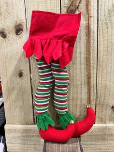 an elf's legs and leggings are attached to a red pepper doll