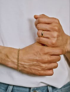 a person wearing a gold chain bracelet