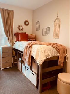 a bedroom with a bed, dressers and other items on the floor in front of a window