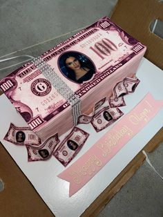 a cake made to look like money with a woman's face on it