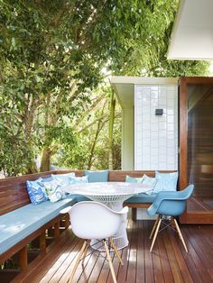 a wooden deck with blue and white furniture