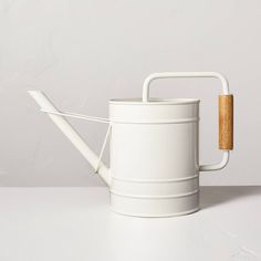 Bring convenience to your gardening chores with the help of this Painted Metal Watering Can from Hearth & Hand™ with Magnolia. Made from metal and featuring a leak-proof design, this watering can features a long that allows for easy watering without upending the can. Plus, a wooden handle makes it easy to carry and use. Showcasing a powder-coated finish in white, it's sure to add traditional charm to your outdoor space. Hearth & Hand™ with Magnolia: Gather ∙ Create ∙ Enjoy Outdoor Planter Boxes, Malibu Home, Hearth & Hand With Magnolia, Metal Watering Can, Indoor Outdoor Planter, Garden Tool Set, Dark Copper, Scandinavian Interior Design, Hearth And Hand