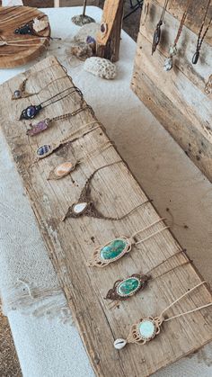 an old wooden board with many different pieces of jewelry hanging on it's sides