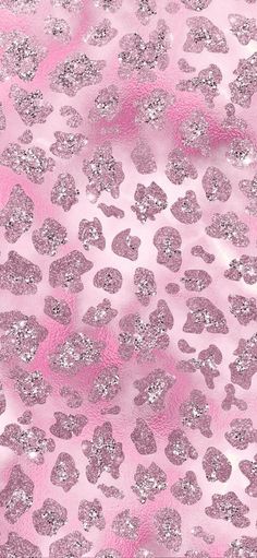 pink and silver glitter cheetah print fabric with hearts on the bottom, as well as an animal pattern