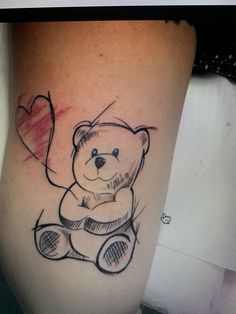 a teddy bear with a heart tattoo on the thigh