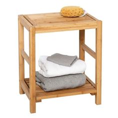 a wooden table with towels on it