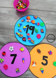 three colorful paper plates with numbers on them