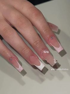 a woman's nails with pink and white designs on them