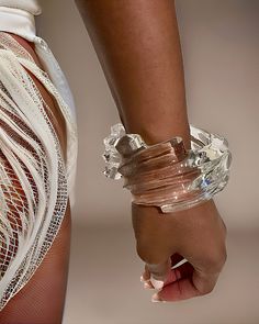 Close-up of a person wearing a Nik Spruill Spiral Liquid Lucite Cuff Bracelet and a white fringed garment, featuring an eye-catching cascading wave detail. Vitaly Jewelry, Blue Alien, Celestial Blue, Couture Details, Plastic Jewelry, Couture Tops, Jewelry Business, Wedding Bracelet, Tear Drop