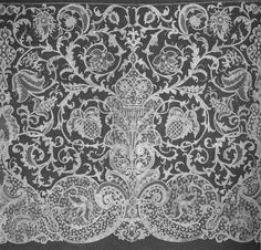 an old black and white photo of a lace curtain with floral designs on the side