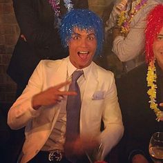 two men with blue hair and wigs at a party