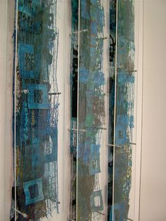 a room divider made out of glass with blue and green designs on it's sides