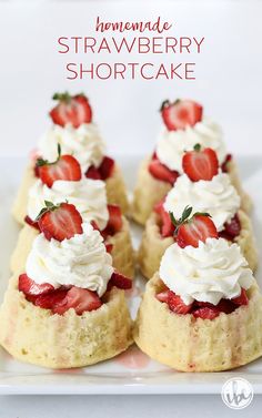 strawberry shortcakes on a white plate with whipped cream and strawberries in the middle