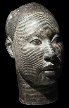 the head of an ancient statue with lines on it's face and shoulders, against a black background