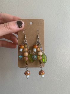 a pair of earrings is being held up