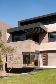 a modern house that has stairs leading up to it