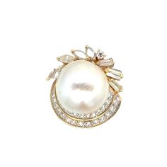 This beautiful baroque pearl diamond cocktail ring is a stunning piece of jewelry, crafted in 18 karat yellow gold, that exudes vintage charm and sophistication. At the center of the ring sits a 16mm white baroque pearl, renowned for its unique and irregular shape, which adds an element of natural beauty and elegance to the piece. Surrounding the pearl are marquise, round brilliant, and baguette-cut diamonds, carefully arranged in a dazzling array of shapes and sizes. The diamonds, weighing appr Vintage Cocktail Ring, Diamond Cocktail Ring, Diamond Cocktail Rings, Baguette Cut Diamond, Vintage Cocktail, Pearl Diamond, Baguette Cut, Baroque Pearls, Cocktail Ring