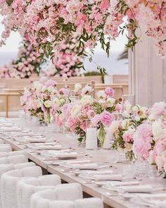 a long table with white and pink flowers on it