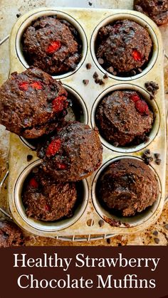 chocolate muffins with strawberries in a cupcake tin ready to be eaten