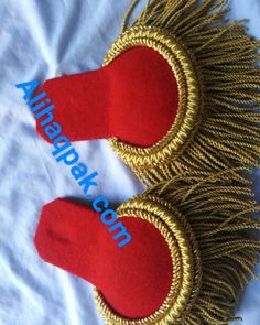 two red and gold handmade knick knacks on top of a white sheet